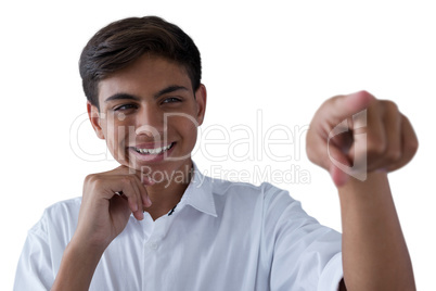 Teenage boy pressing an invisible virtual screen