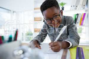 Portrait of businessman writing on paper