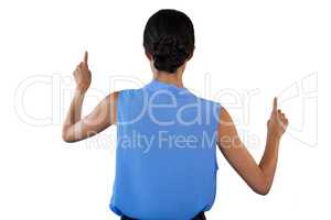 Rear view of businesswoman in sleeveless clothing pointing on interface