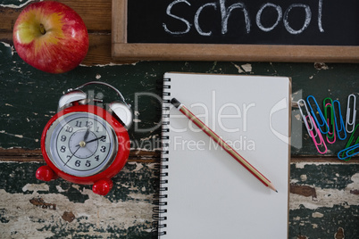 Text written on slate with school supplies