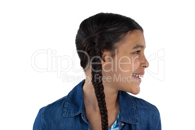 Smiling cute girl standing against white background