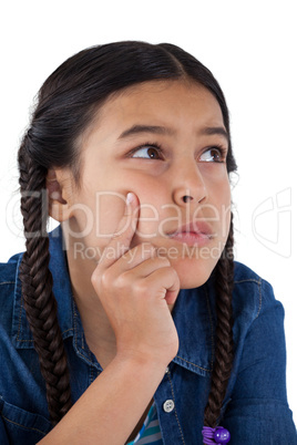 Girl with hand on chin against white background