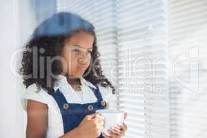 Thoughtful businesswoman seen through window
