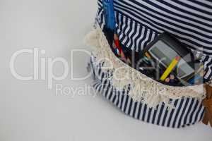 Schoolbag with various supplies on white background