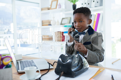 Businessman looking away while talking on telephone