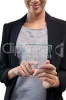 Mid section of smiling businesswoman touching glass interface