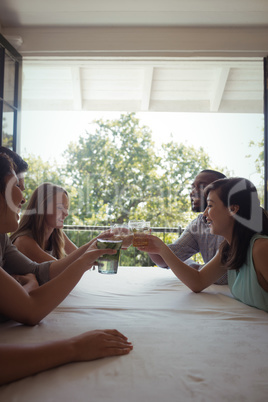 Group of friends toasting cocktail glasses