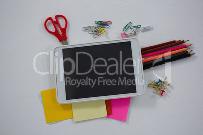 Various school supplies and digital tablet on white background