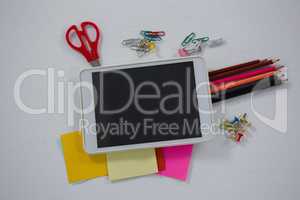 Various school supplies and digital tablet on white background
