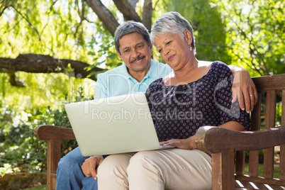 Senior couple using laptop