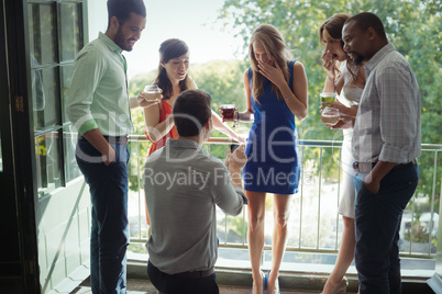 Man proposing woman with engagement ring