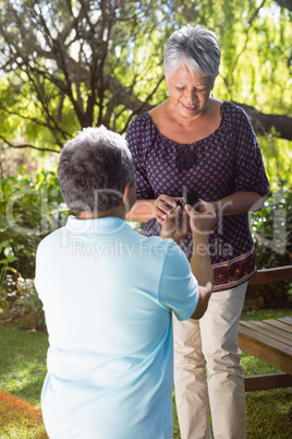 Senior man proposing woman by gifting ring