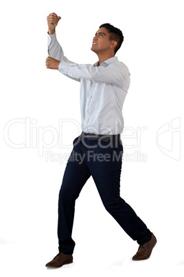 Full length of businessman pulling invisible rope