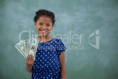 Portrait of girl showing paper currency
