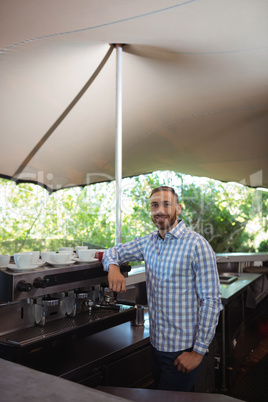 Male owner standing at outdoor cafÃ?Â©