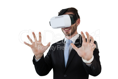 Happy businessman with vr glasses gesturing against white background