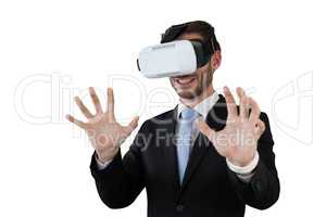 Happy businessman with vr glasses gesturing against white background