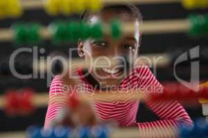 Cute little girl counting on abacus