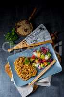 Meat strips in spicy sweet and sour sauce and green salad