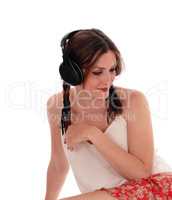Woman sitting on floor with headset.