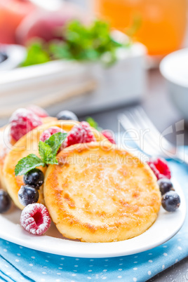 Cottage cheese pancakes, syrniki, curd fritters with berries