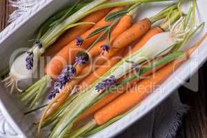 Young carrots and spring onions prepared for baking