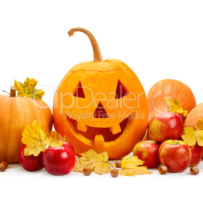 pumpkin-head, nuts, apples and yellow leaves isolated on white