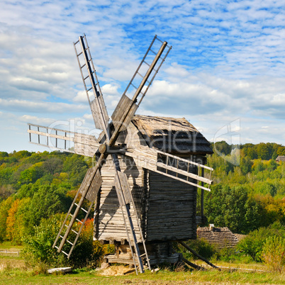 old wooden windmill in field