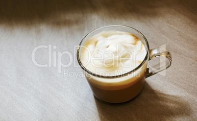 Glass mug with foamy cappuccino