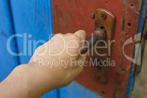 Woman hand open old wooden door