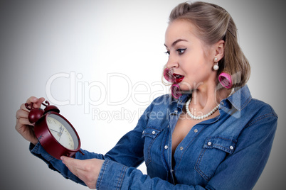 Young woman with alarm clock