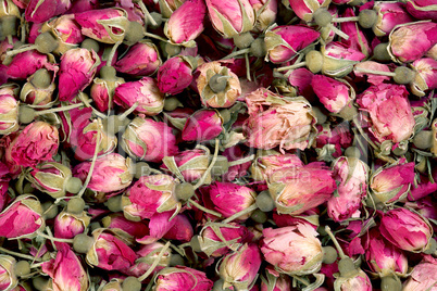Dried rosebuds background texture closeup.