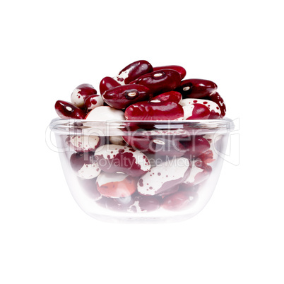 Sprouted beans in a saucer on white background.