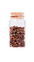 Dried cloves in a glass bottle with cork stopper, isolated on wh
