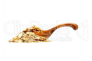 Pumpkin seeds in the wooden spoon, isolated on white background.