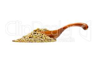 Mung beans in the wooden spoon, isolated on white background.
