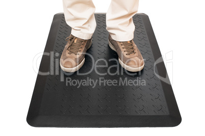 Black mat with man standing.