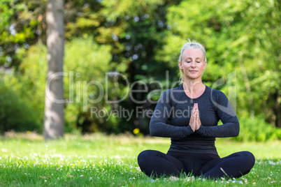 Mature Middle Aged Fit Healthy Woman Practicing Yoga Outside