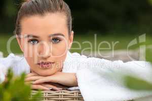 Beautiful Young Woman Relaxing in Robe at Health Spa