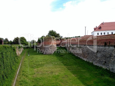 The main defensive wall of the Dubensk castle. View from the bridge. Summer day .
