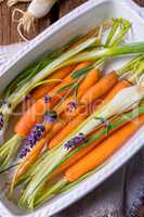 Young carrots and spring onions prepared for baking