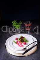 Carpaccio of baked red pray with green salad and raspberry