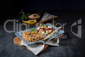 Meat strips in spicy sweet and sour sauce and green salad