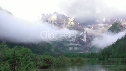 Mixture of Clouds with a Mist over a Mountain Lake. Fast Motion