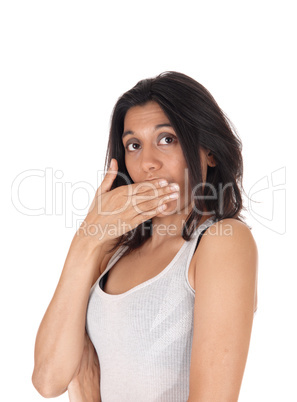 Woman holding hand over mouth looking surprised.