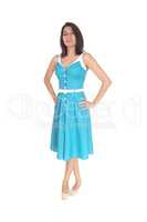 Beautiful Hispanic woman standing in blue dress.