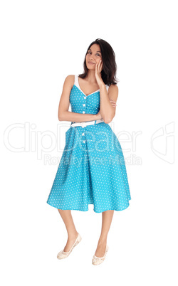 Lovely young woman in standing in a blue dress.