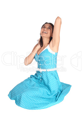 Gorgeous woman sitting on floor and laughing.