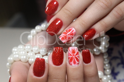Manicure nails extensively bright red
