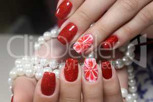 Manicure nails extensively bright red